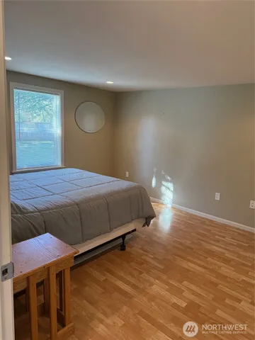 a bedroom with a bed and window