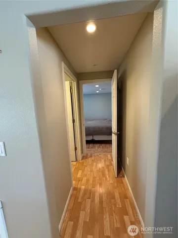 a view of a hallway with wooden floor