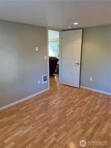 an empty room with closet and bathroom