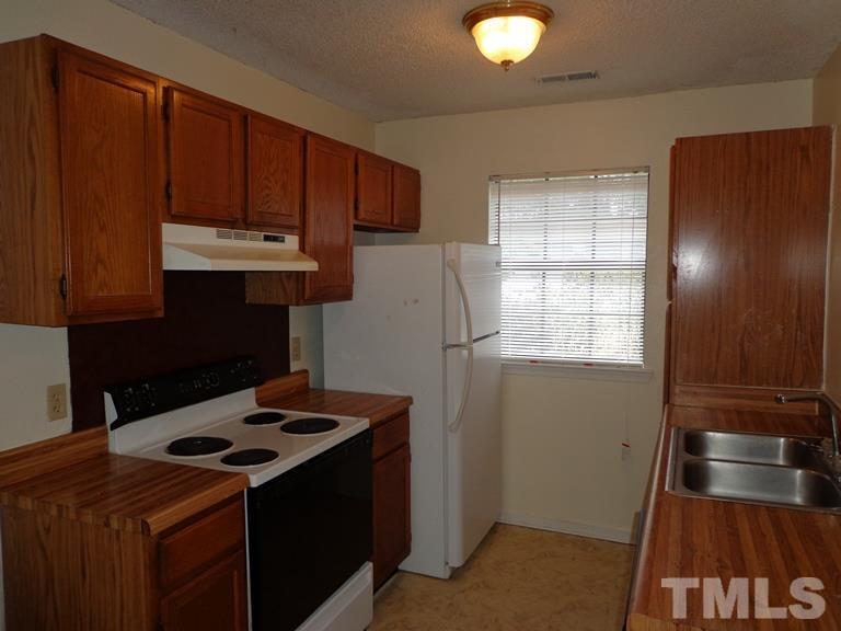 5551 Fieldcross Court Raleigh, NC 27610 - Photo 2 of 3 a kitchen with a stove and a cabinet