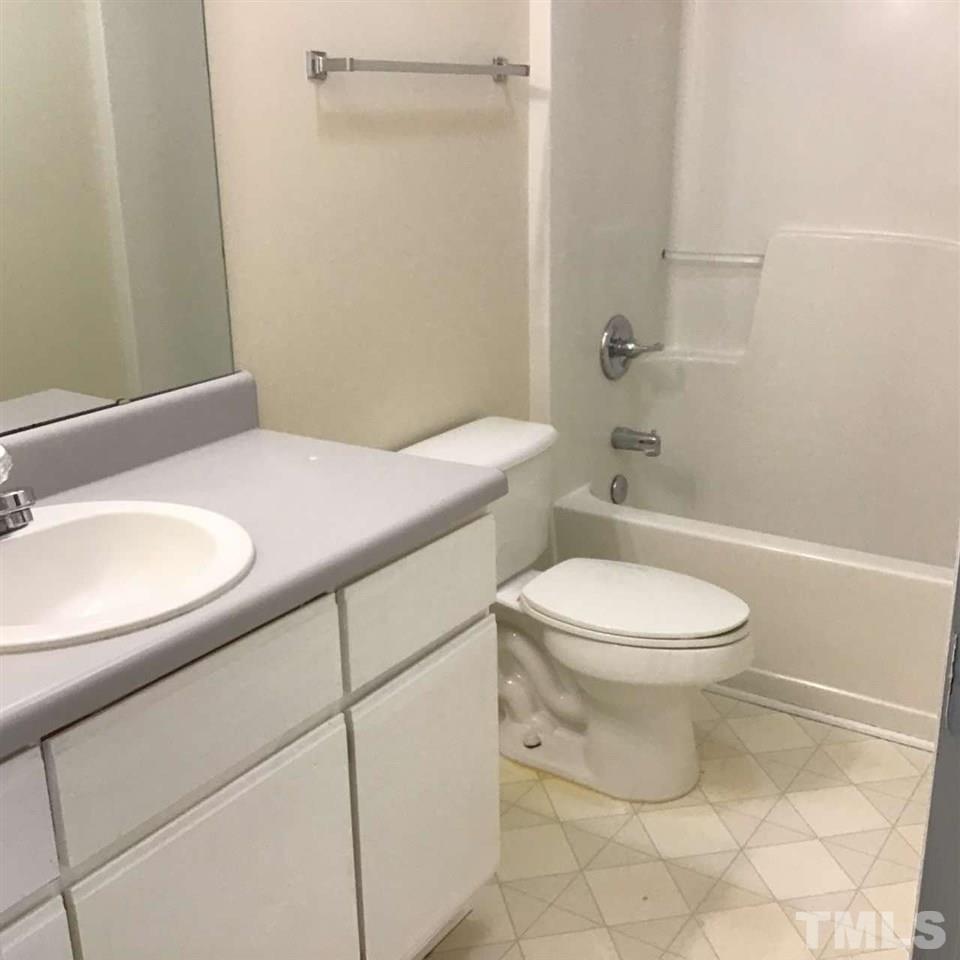 5551 Fieldcross Court Raleigh, NC 27610 - Photo 3 of 3 a bathroom with a sink a toilet and shower