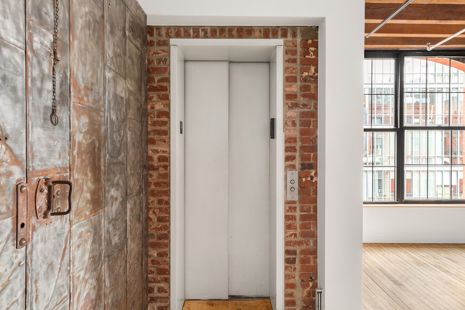 554 Broome Street, Unit 4 Manhattan, NY 10013 - Photo 10 of 13 a view of an entryway with wooden floor and windows
