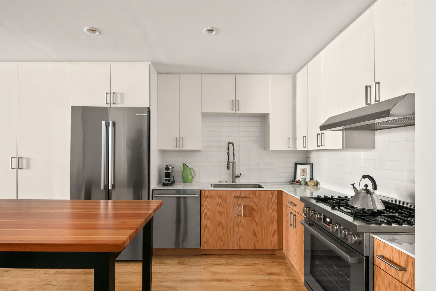 554 Broome Street, Unit 4 Manhattan, NY 10013 - Photo 3 of 13 a kitchen with stainless steel appliances granite countertop a sink stove and refrigerator