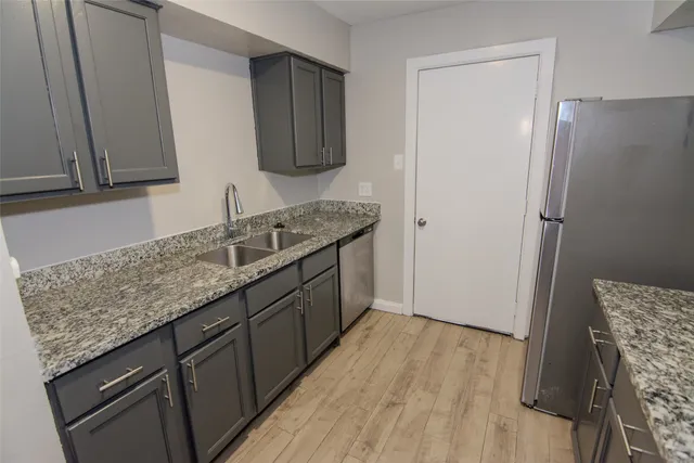 a kitchen with a sink stove and refrigerator