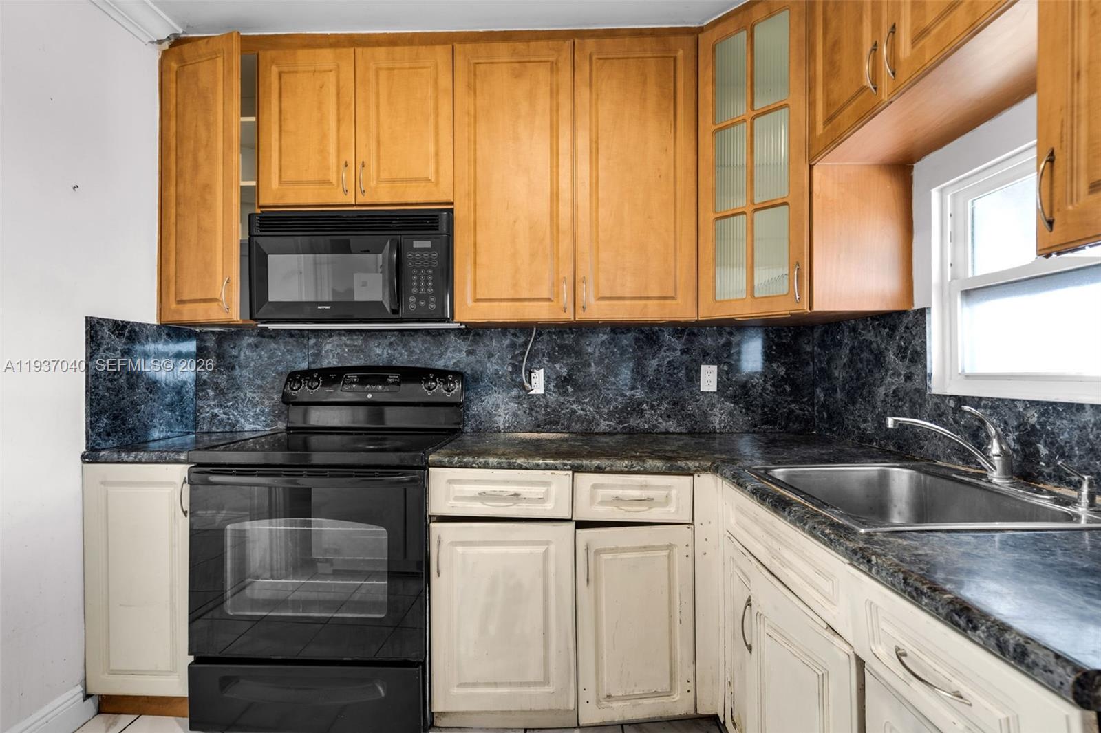 2007 Southwest 60th Avenue Miami, FL 33155 - Photo 12 of 26 a kitchen with granite countertop a sink and a stove