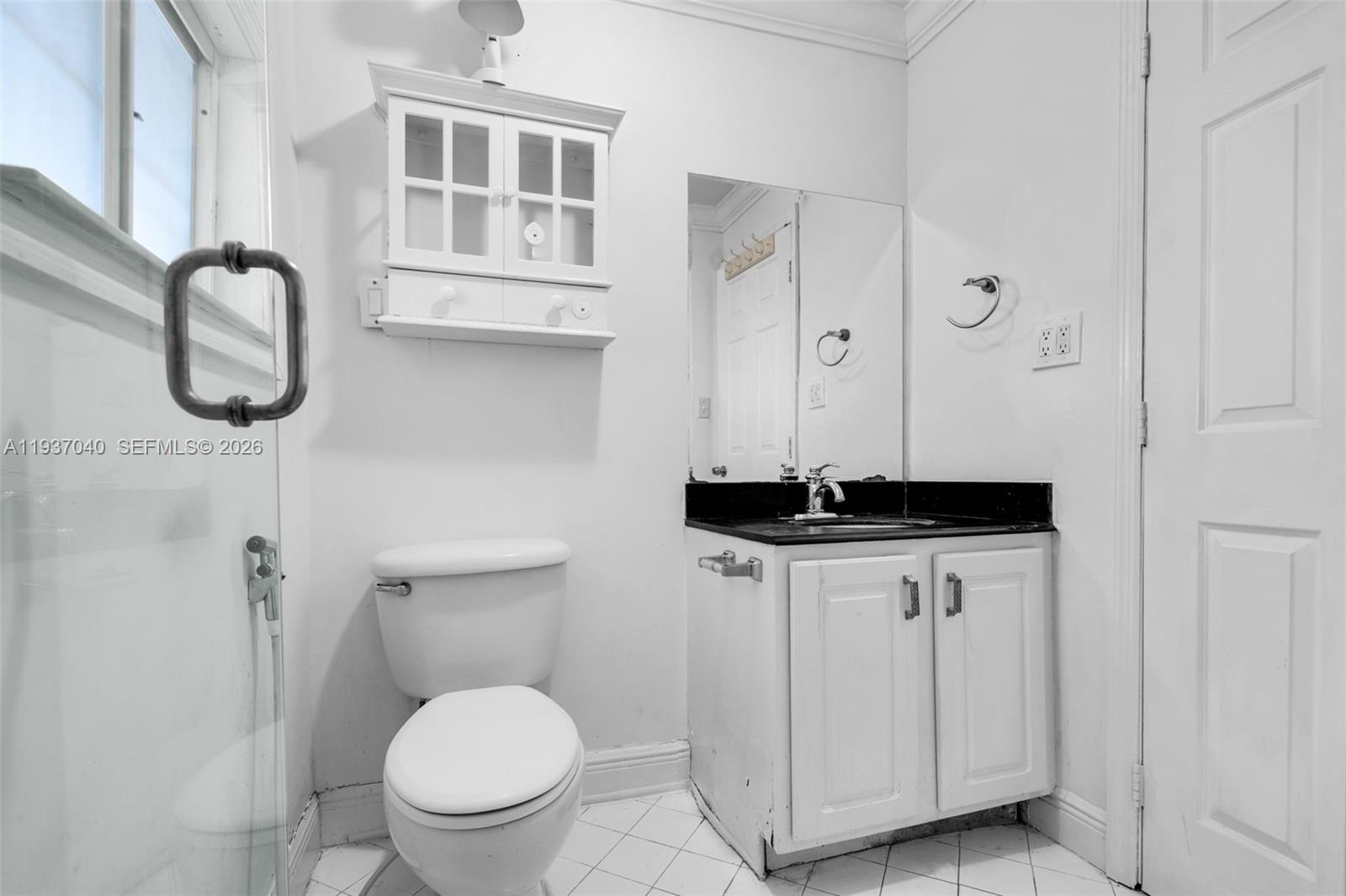 2007 Southwest 60th Avenue Miami, FL 33155 - Photo 13 of 26 a bathroom with a sink a toilet and a mirror