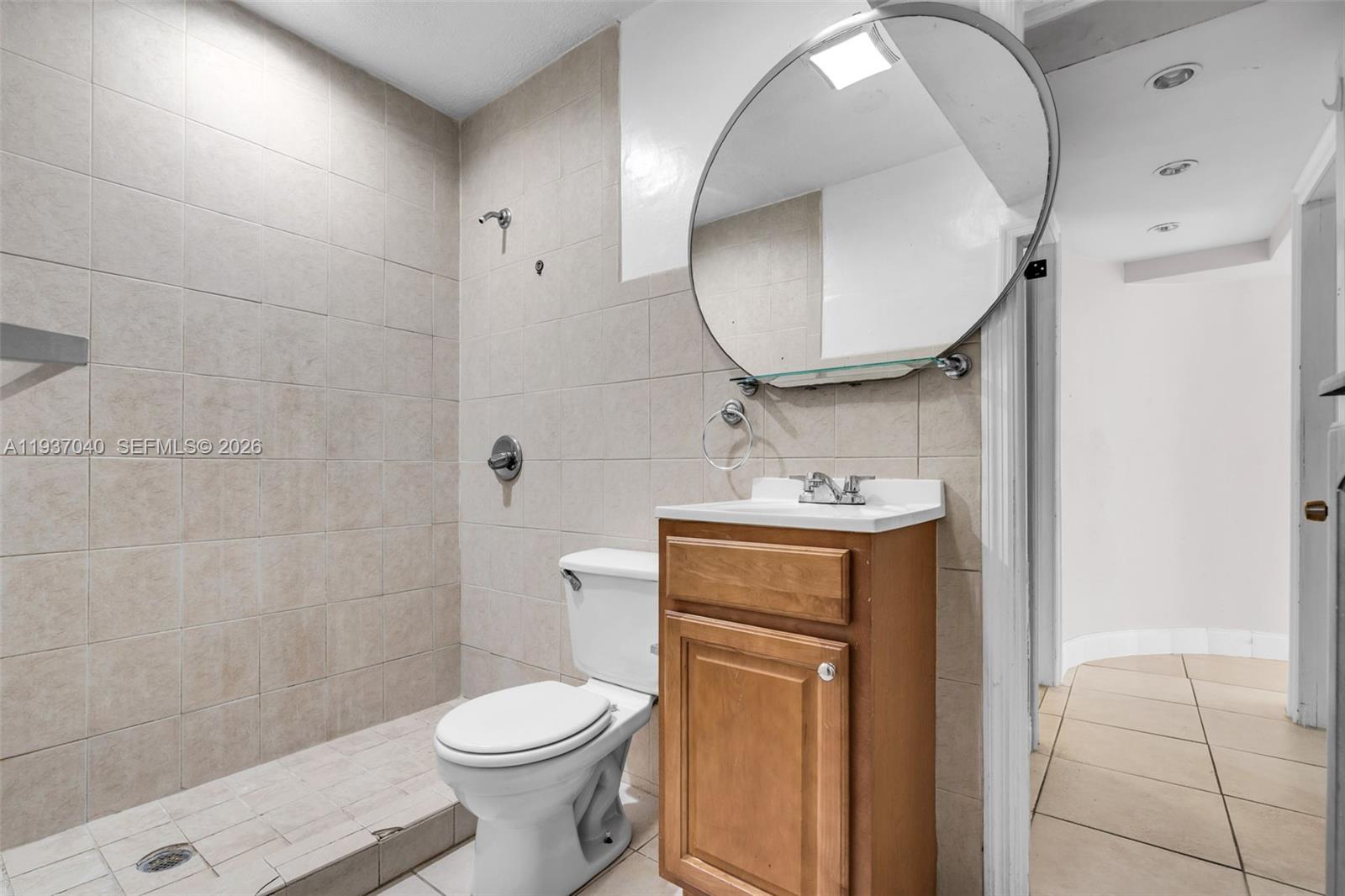 2007 Southwest 60th Avenue Miami, FL 33155 - Photo 16 of 26 a bathroom with a toilet sink and mirror