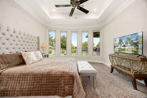a bedroom with a large bed and a window
