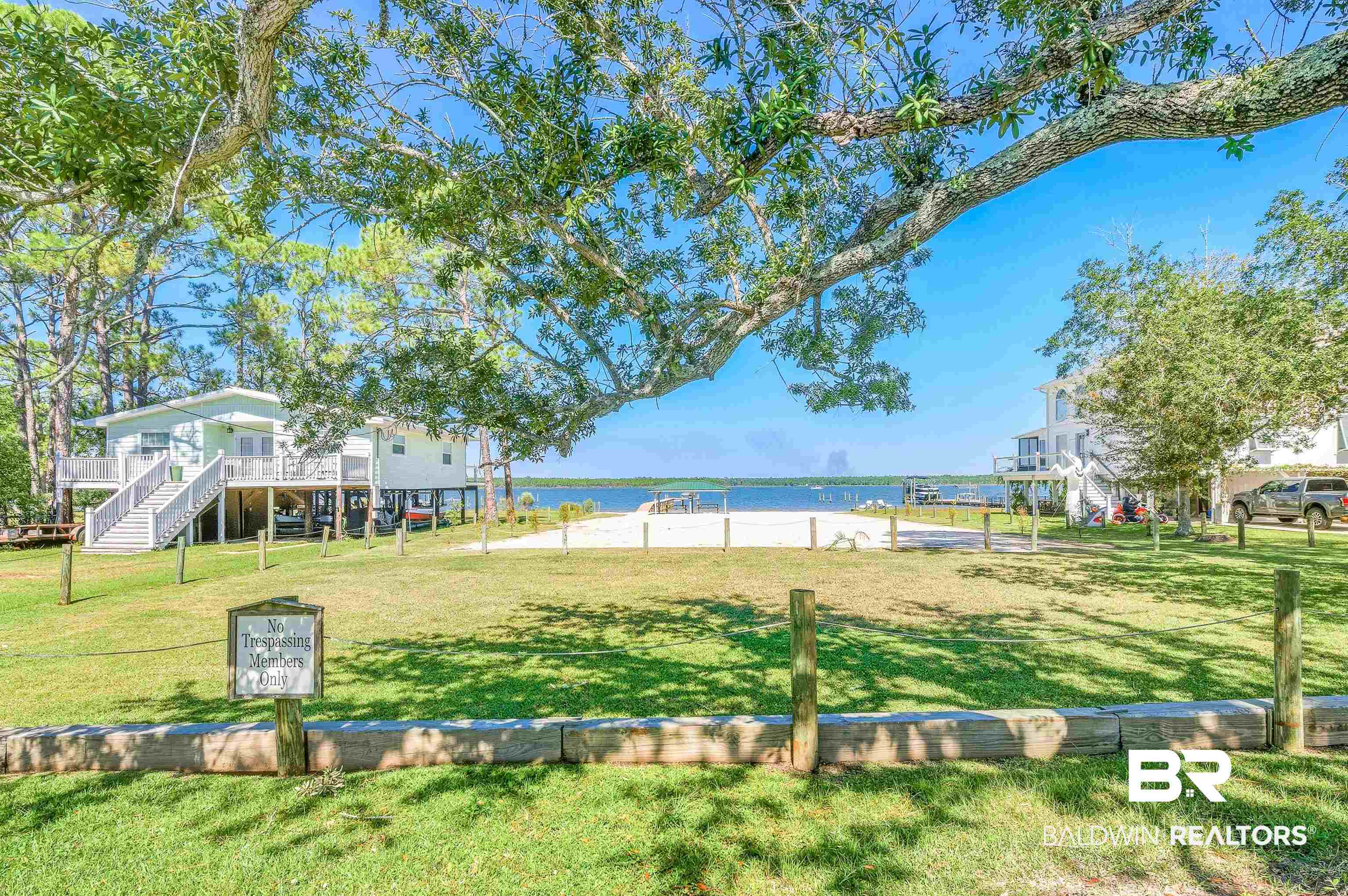 5310 Pine Road Orange Beach, AL 36561 - Photo 36 of 46 View of community featuring stairway, a yard, and a deck with water view