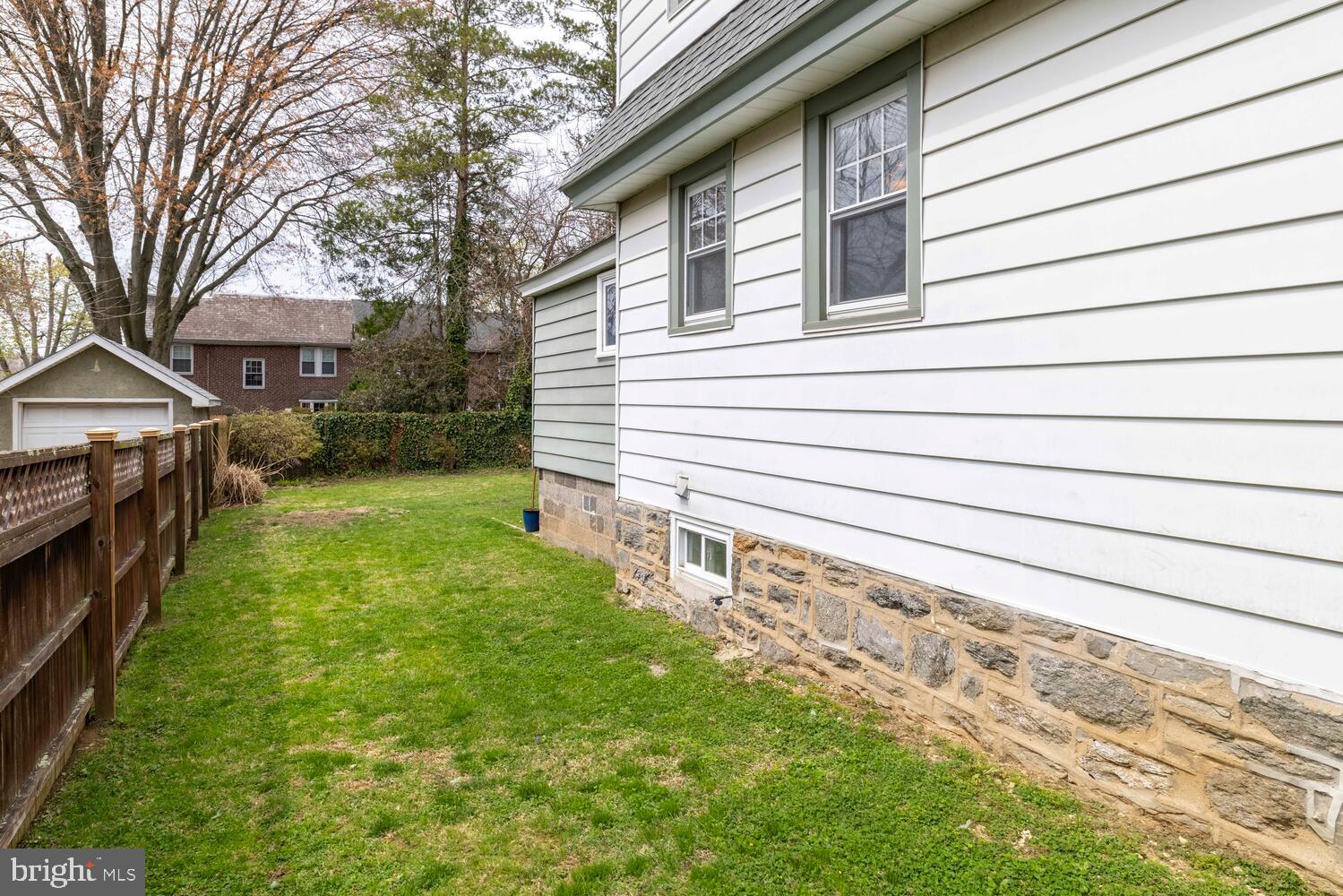 2116 East County Line Road Ardmore, PA 19003 - Photo 36 of 38 a view of a backyard with plants and large trees