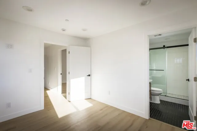 a view of a room with wooden floor and bathroom
