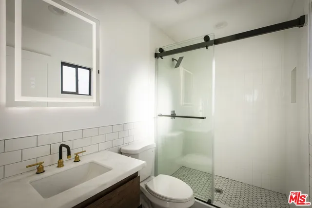 a bathroom with a sink toilet and shower