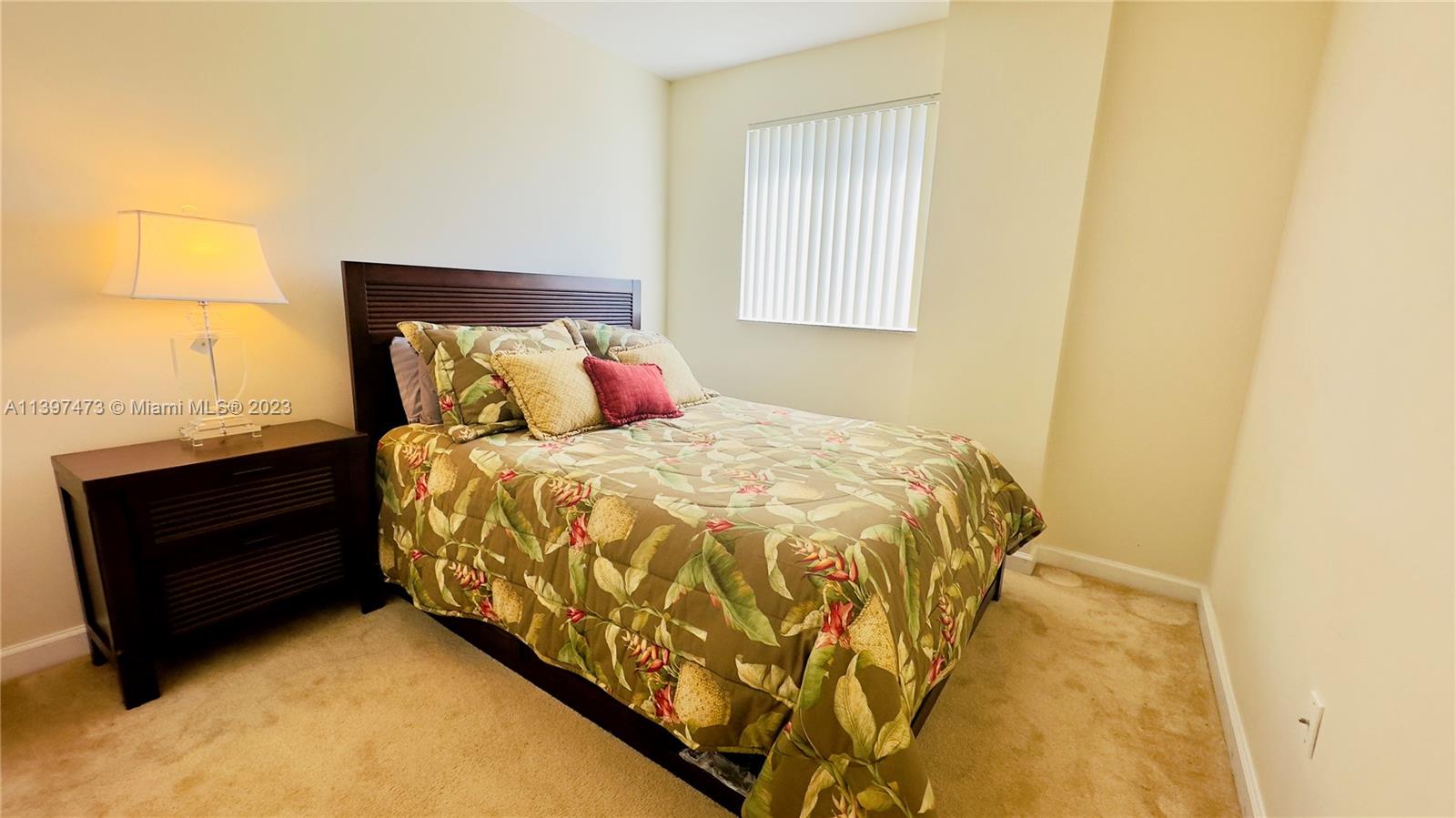 2280 Southwest 32nd Avenue, Unit 315 Miami, FL 33145 - Photo 16 of 21 a bed sitting in a bedroom next to a window