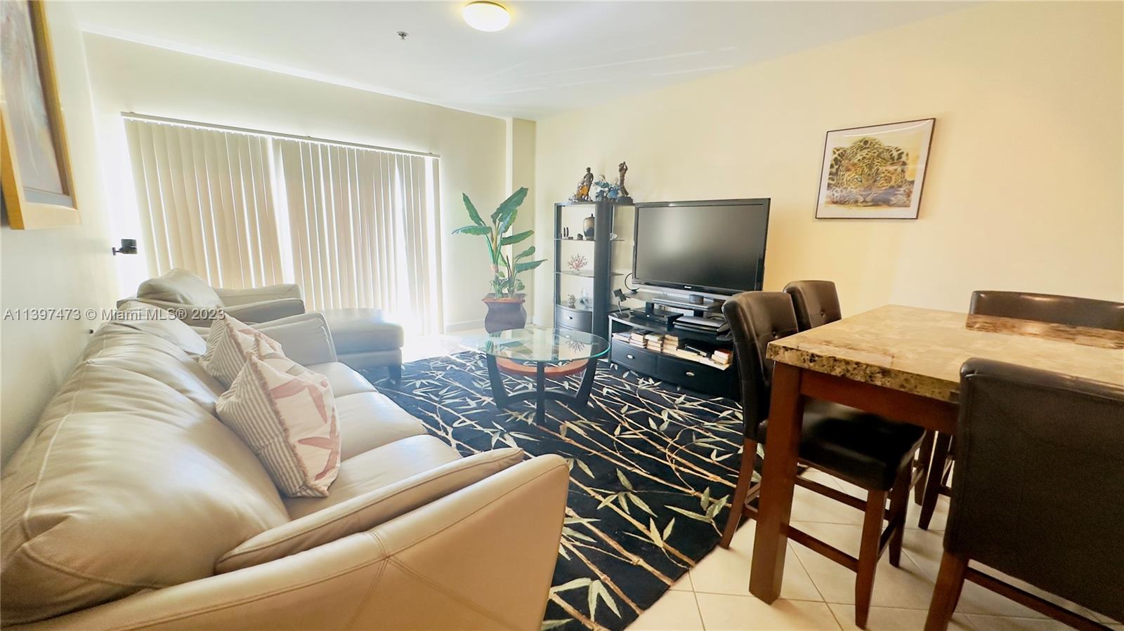 2280 Southwest 32nd Avenue, Unit 315 Miami, FL 33145 - Photo 17 of 21 a living room with furniture and a flat screen tv