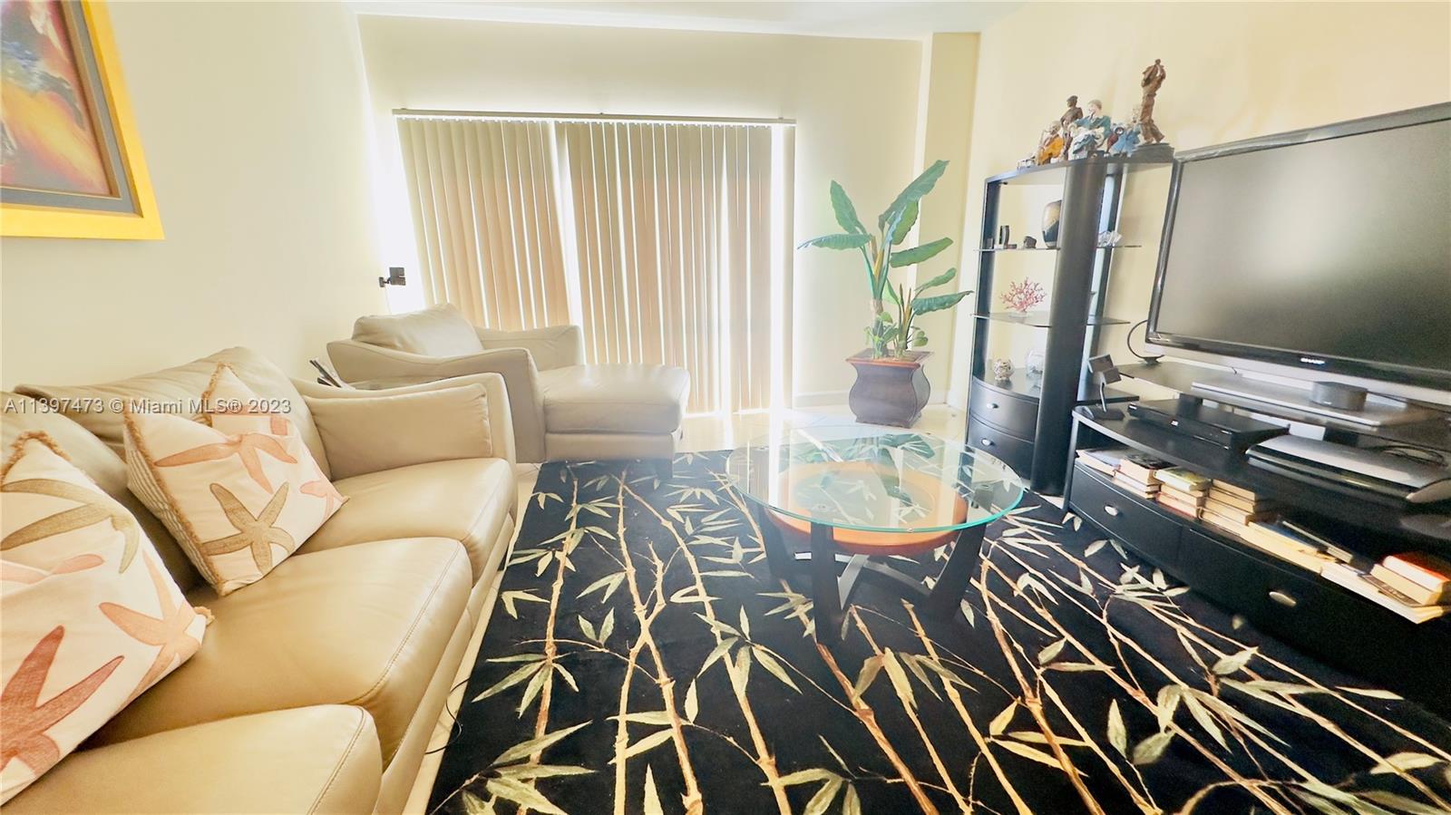 2280 Southwest 32nd Avenue, Unit 315 Miami, FL 33145 - Photo 19 of 21 a living room with furniture and a flat screen tv