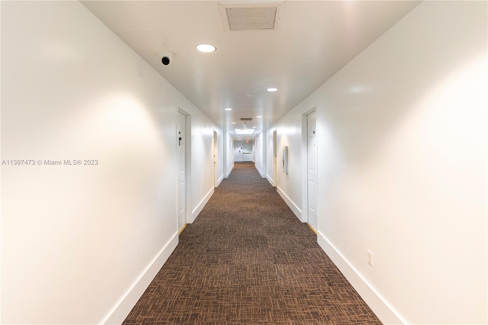 2280 Southwest 32nd Avenue, Unit 315 Miami, FL 33145 - Photo 5 of 21 a view of a hallway with a couch