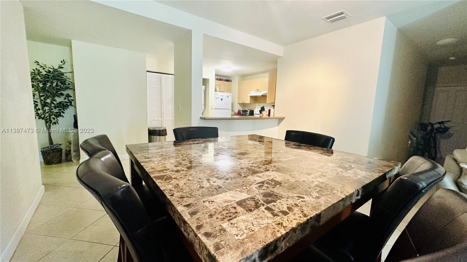 2280 Southwest 32nd Avenue, Unit 315 Miami, FL 33145 - Photo 6 of 21 a view of kitchen island with granite countertop living room and couch