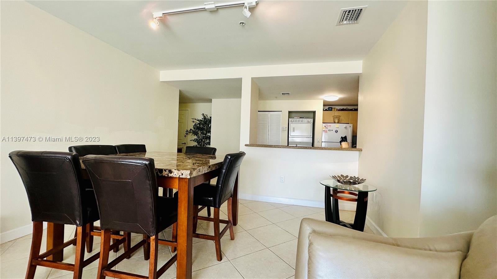 2280 Southwest 32nd Avenue, Unit 315 Miami, FL 33145 - Photo 10 of 21 a view of a dining room with furniture and wooden floor