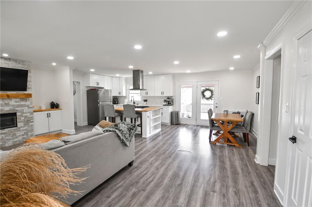 150 Sims Street Winder, GA 30680 - Photo 10 of 61 a living room with stainless steel appliances furniture wooden floor and a view of kitchen