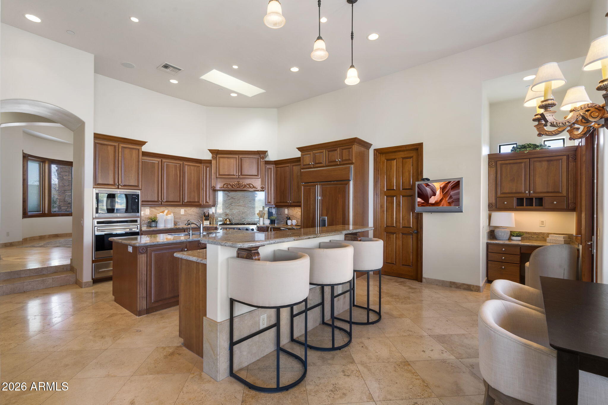 9624 Copper Ridge Trail Fountain Hills, AZ 85268 - Photo 13 of 57 a kitchen with stainless steel appliances kitchen island granite countertop a sink a stove and a refrigerator with wooden floor