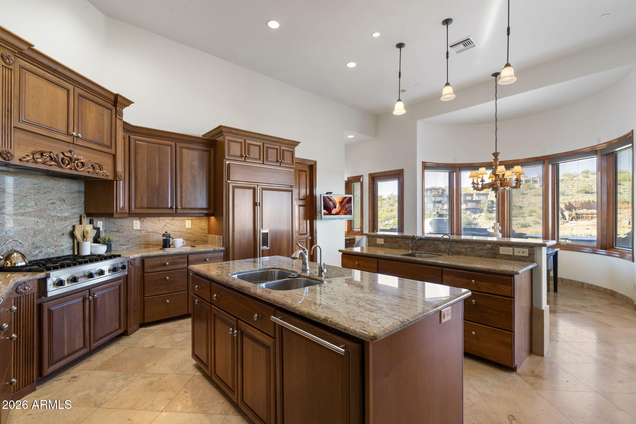 9624 Copper Ridge Trail Fountain Hills, AZ 85268 - Photo 14 of 57 a kitchen with stainless steel appliances granite countertop wooden cabinets a sink dishwasher a stove and a refrigerator