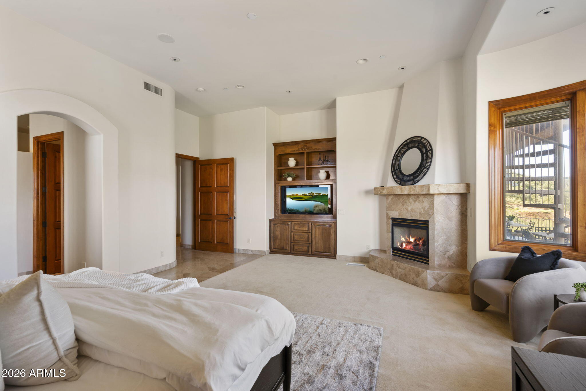 9624 Copper Ridge Trail Fountain Hills, AZ 85268 - Photo 19 of 57 a bedroom with a large bed and a fireplace
