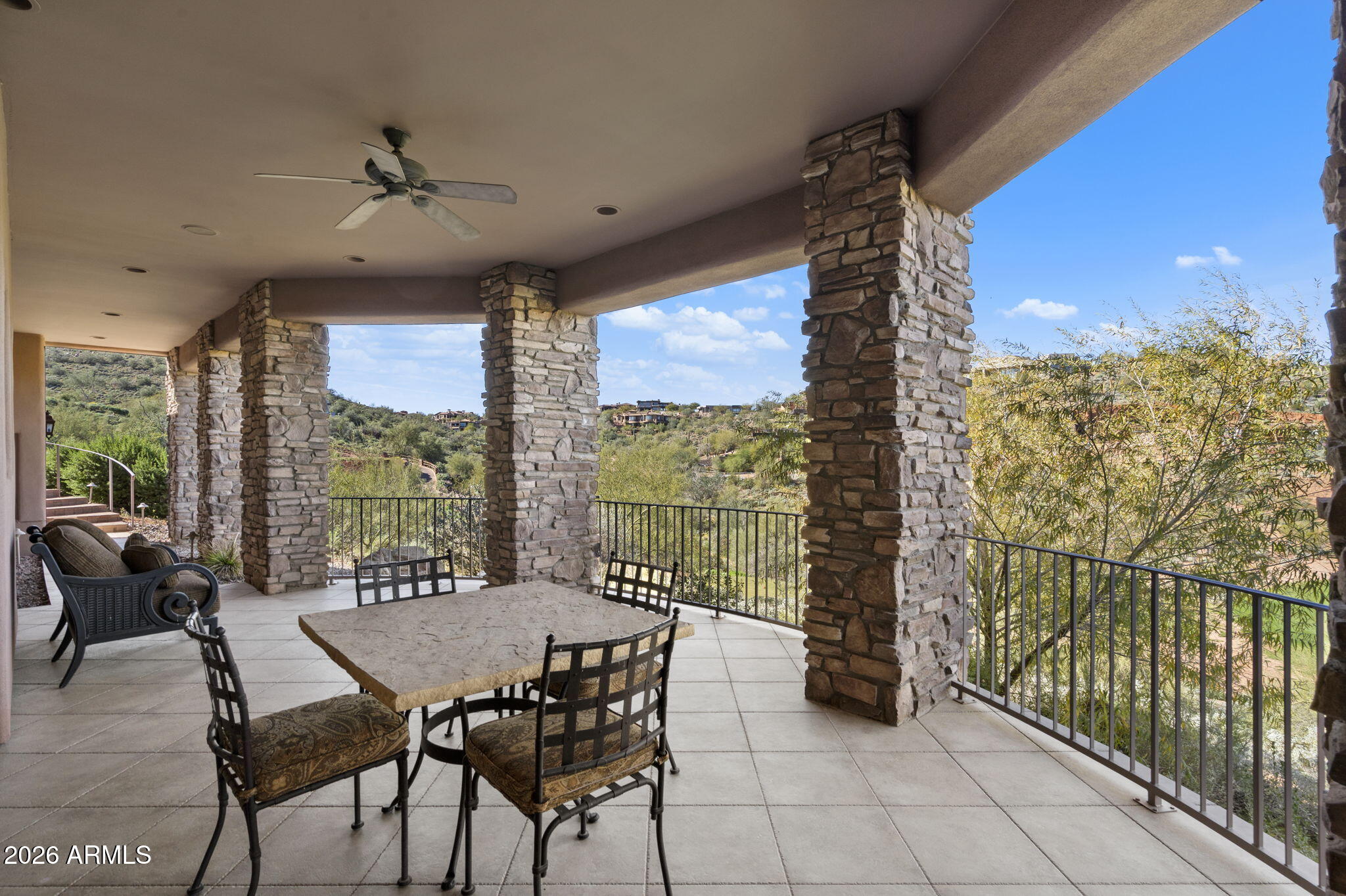 9624 Copper Ridge Trail Fountain Hills, AZ 85268 - Photo 30 of 57 a view of a balcony dining table and chairs with wooden floor