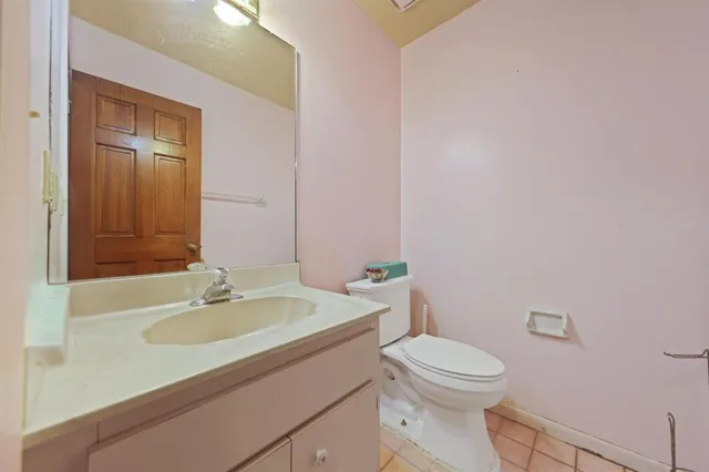 a bathroom with a sink a toilet and mirror