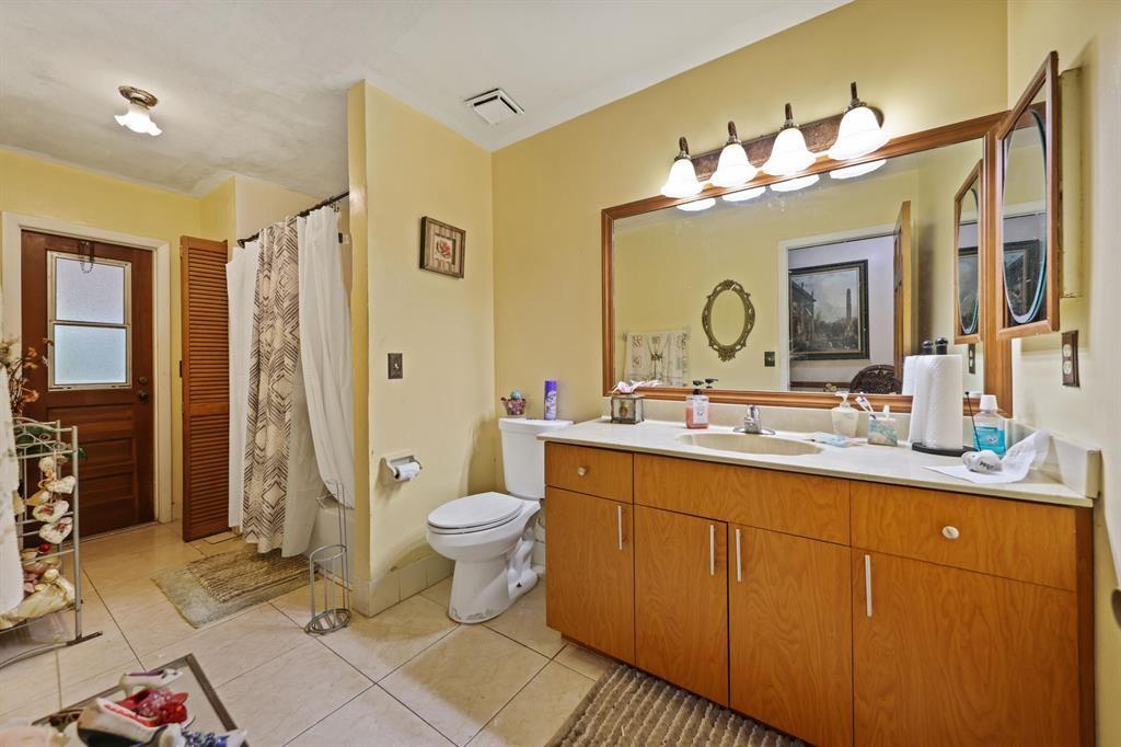 5172 Northwest 84th Road Coral Springs, FL 33067 - Photo 13 of 24 a bathroom with a double vanity sink mirror and toilet