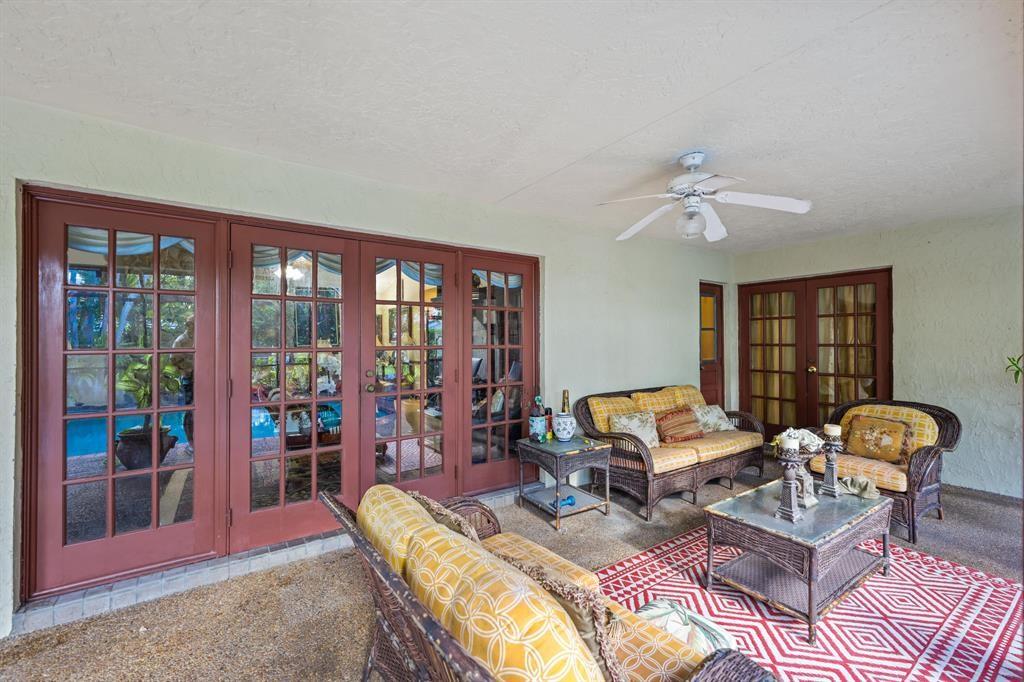 5172 Northwest 84th Road Coral Springs, FL 33067 - Photo 19 of 24 a living room with furniture a floor to ceiling window and a flat screen tv