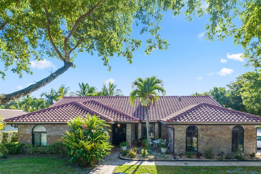 5172 Northwest 84th Road Coral Springs, FL 33067 - Photo 20 of 24 a front view of a house with garden
