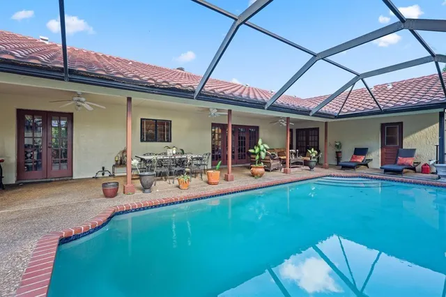 a view of a chairs and table in patio with a barbeque grill