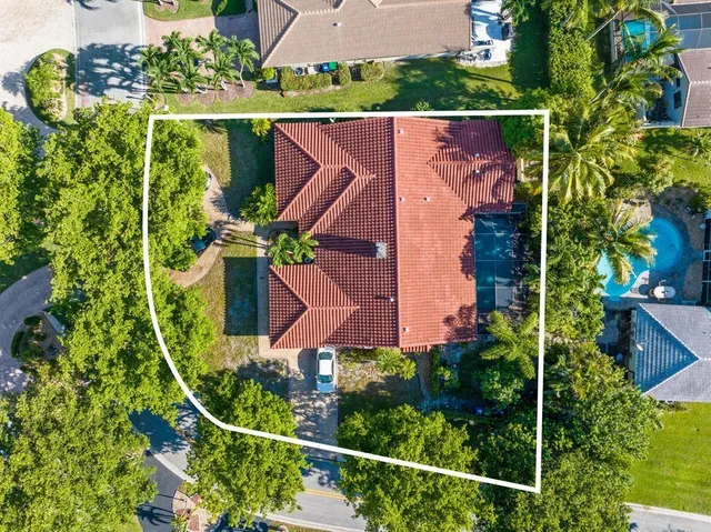 an aerial view of house with yard swimming pool and outdoor seating