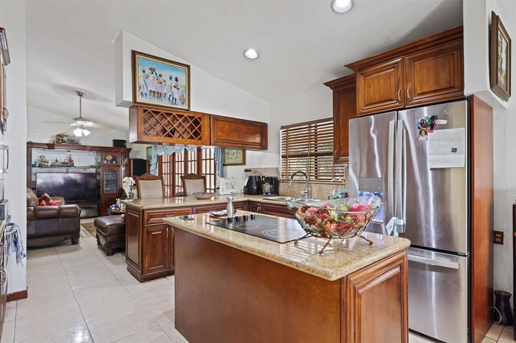 5172 Northwest 84th Road Coral Springs, FL 33067 - Photo 3 of 24 a kitchen with stainless steel appliances granite countertop a sink stove and refrigerator