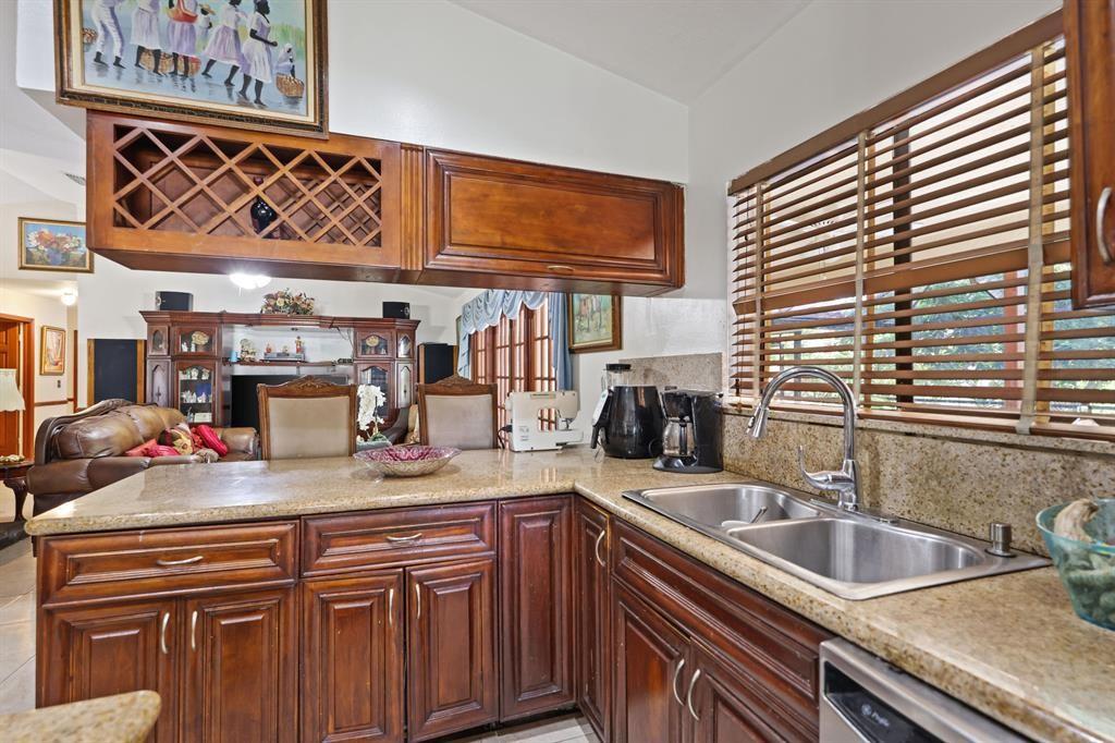 5172 Northwest 84th Road Coral Springs, FL 33067 - Photo 4 of 24 a kitchen with a sink and cabinets