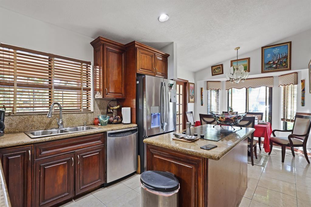 5172 Northwest 84th Road Coral Springs, FL 33067 - Photo 6 of 24 a kitchen with stainless steel appliances a sink stove and cabinets