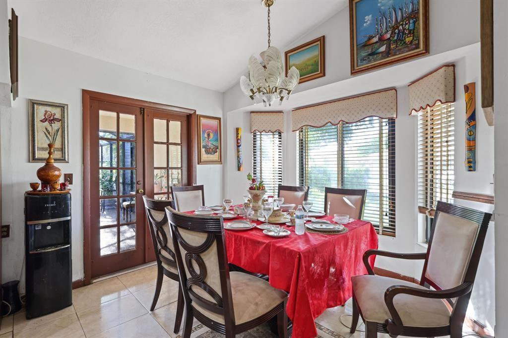5172 Northwest 84th Road Coral Springs, FL 33067 - Photo 9 of 24 a view of a dining room with furniture large windows and wooden floor