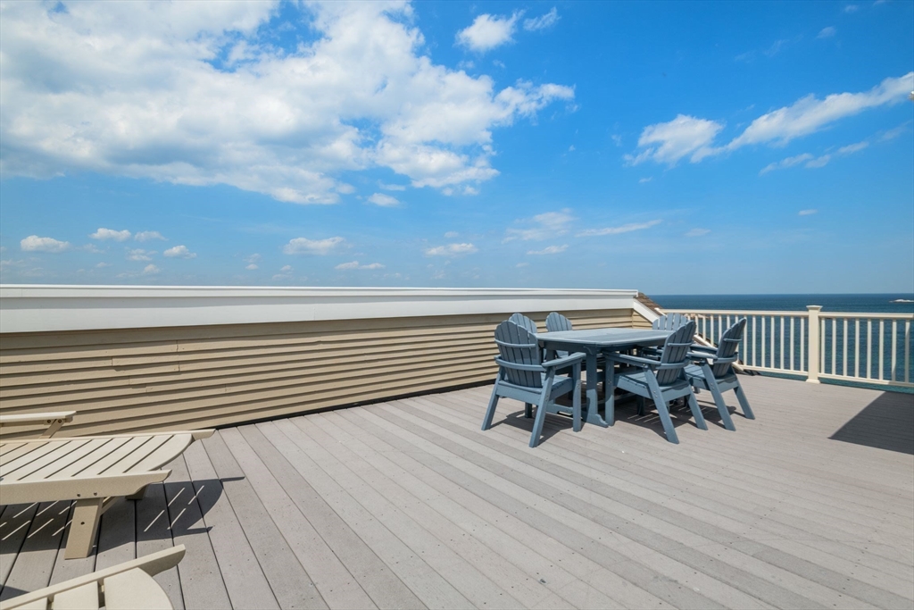 66 Glades Road, Unit 8 Scituate, MA 02066 - Photo 24 of 27 a roof deck with table and chairs and wooden floor