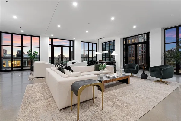 a living room with furniture large window and flat screen tv