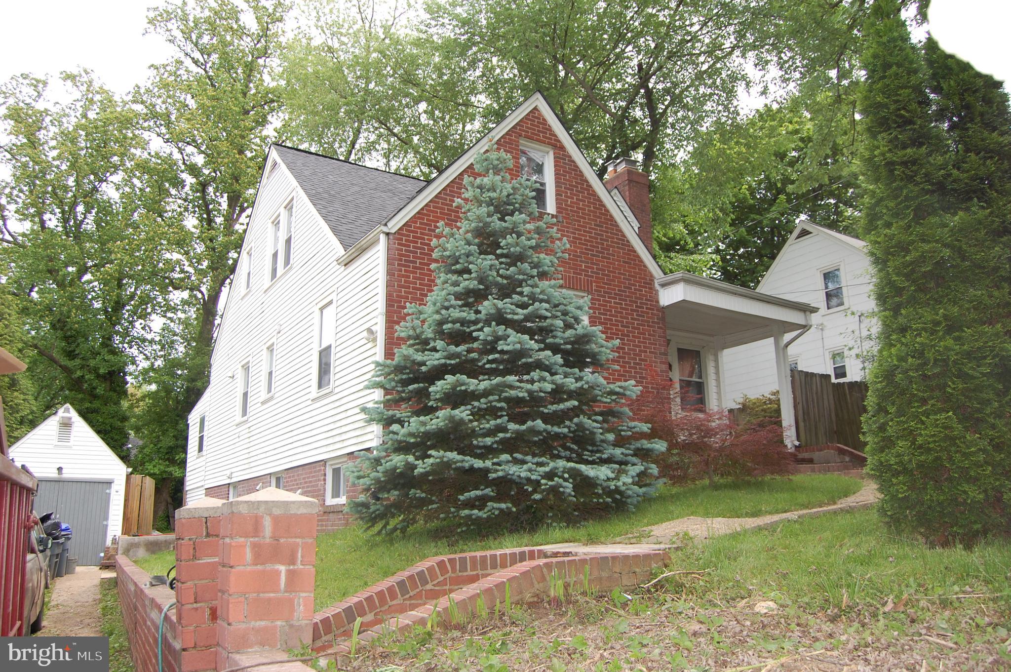 10409 Amherst Avenue Silver Spring, MD 20902 - Photo 3 of 47 Side View with Retaining Wall and Detached Garage