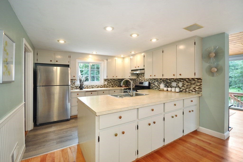 30 Chester Road Boxborough, MA 01719 - Photo 17 of 38 a kitchen with white cabinets sink and refrigerator