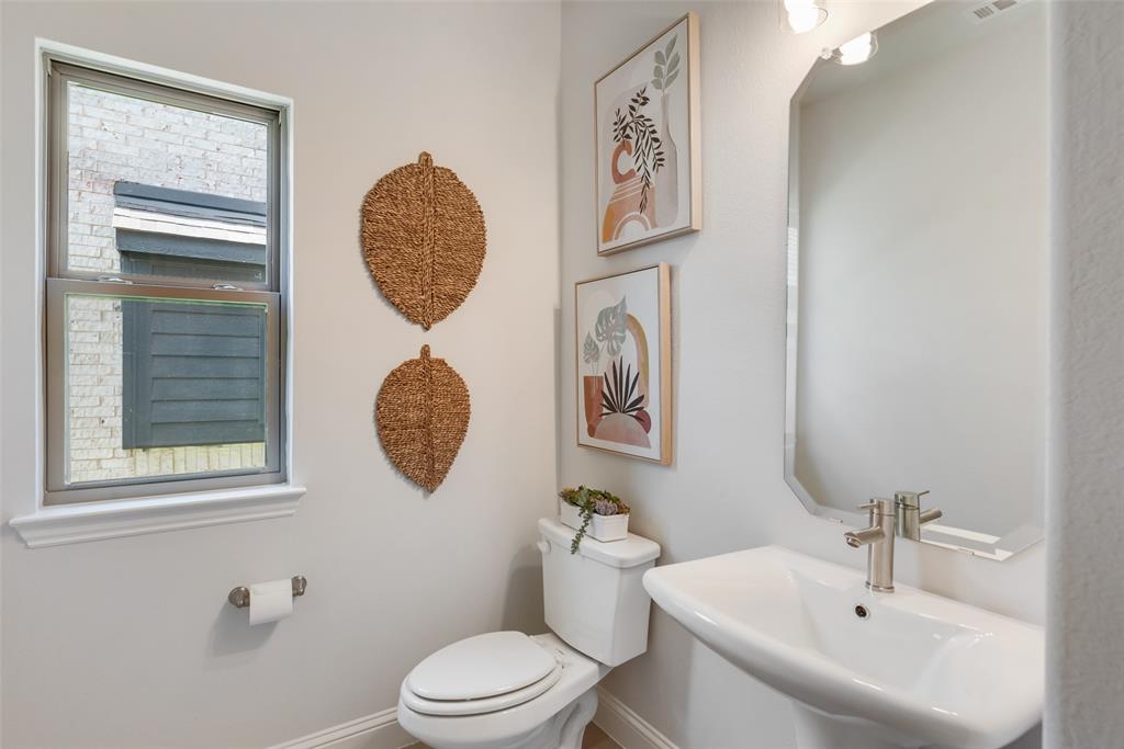 5216 Picasso Road Royse City, TX 75189 - Photo 12 of 25 a bathroom with a toilet a sink and mirror