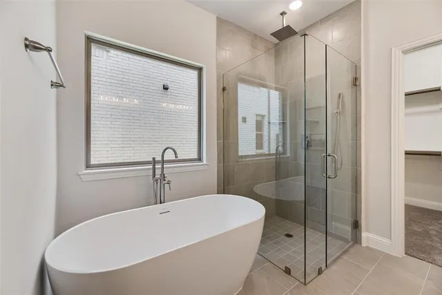 a bathroom with a bathtub and a shower