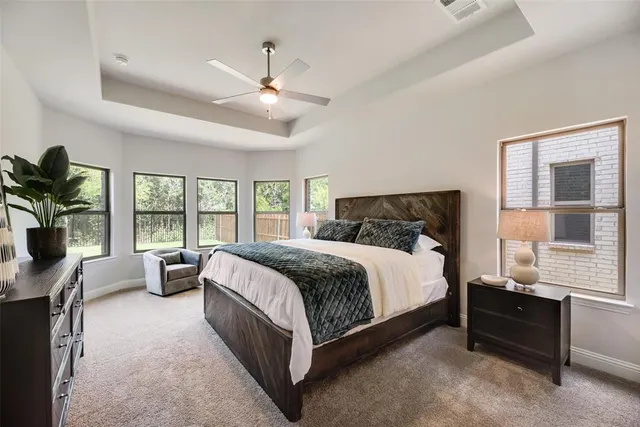 a bedroom with a bed and large window