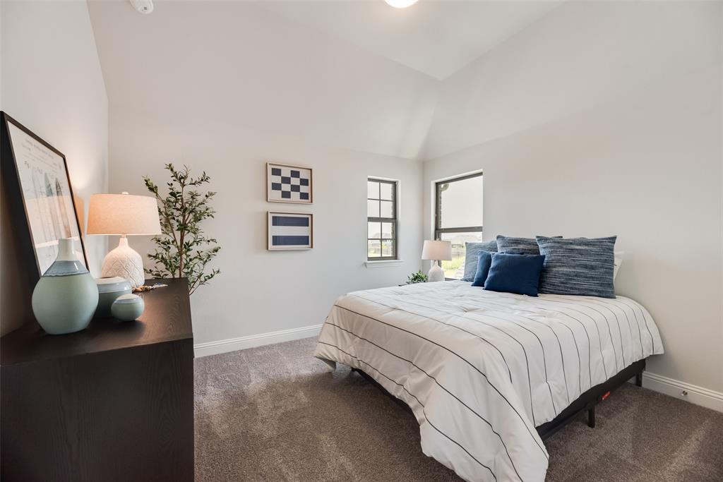 5216 Picasso Road Royse City, TX 75189 - Photo 16 of 25 a bedroom with a bed and a potted plant