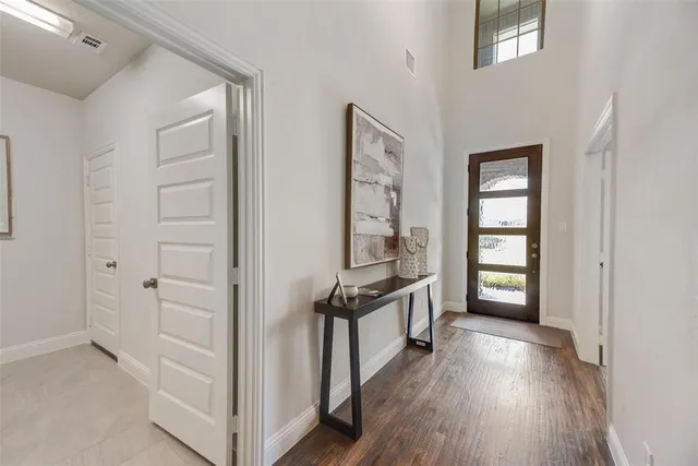 an empty room with windows and wooden floor