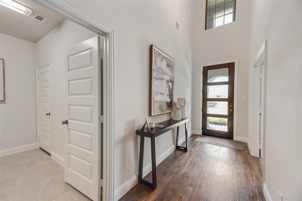 5216 Picasso Road Royse City, TX 75189 - Photo 3 of 25 an empty room with windows and wooden floor