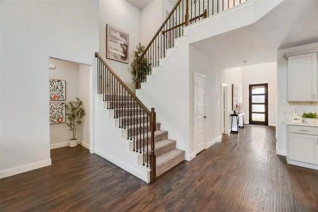 a view of entryway with wooden floor and stairs