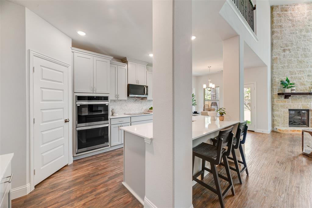 5216 Picasso Road Royse City, TX 75189 - Photo 7 of 25 a kitchen with stainless steel appliances a refrigerator stove microwave and cabinets