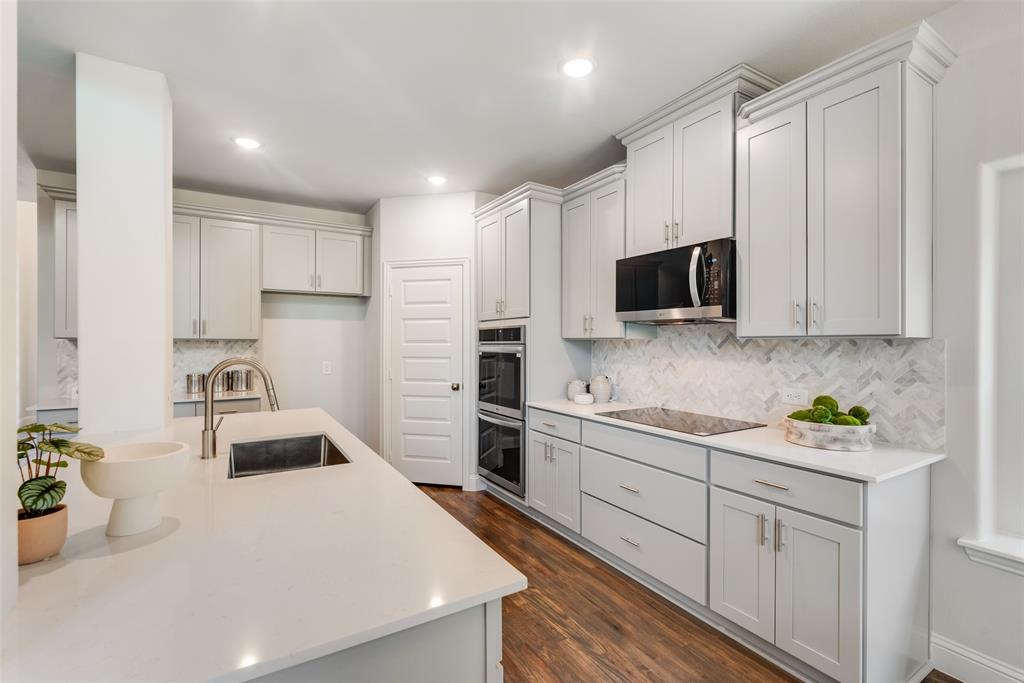 5216 Picasso Road Royse City, TX 75189 - Photo 8 of 25 a kitchen with a sink a stove and cabinets